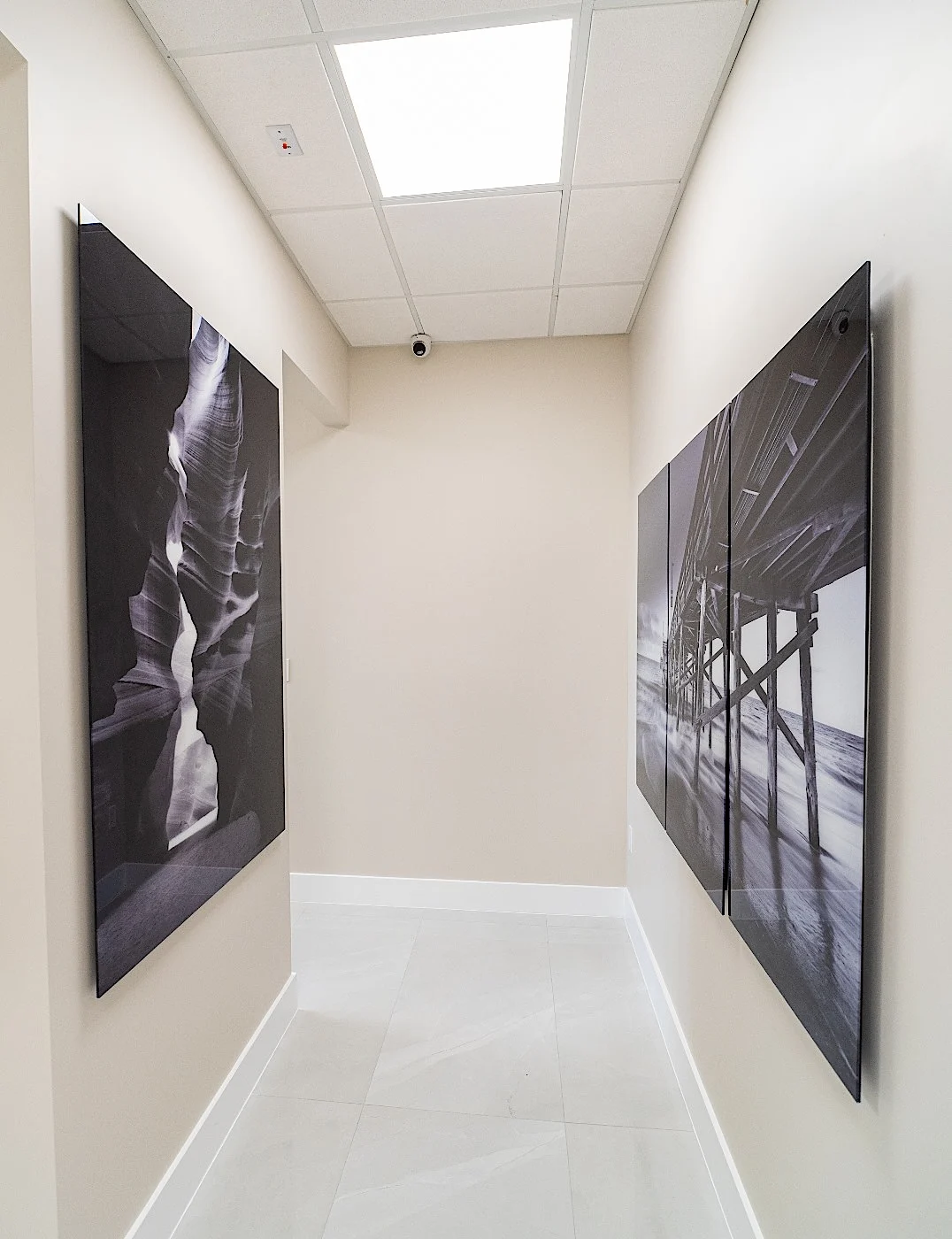 Clear Smiles Dental — Short corridor with two large black-and-white panels facing each other