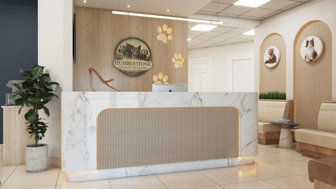 Humberstone Animal Hospital — Reception with a marble-look desk under a round logo with a dog, cat and ferret, beside backlit paw prints