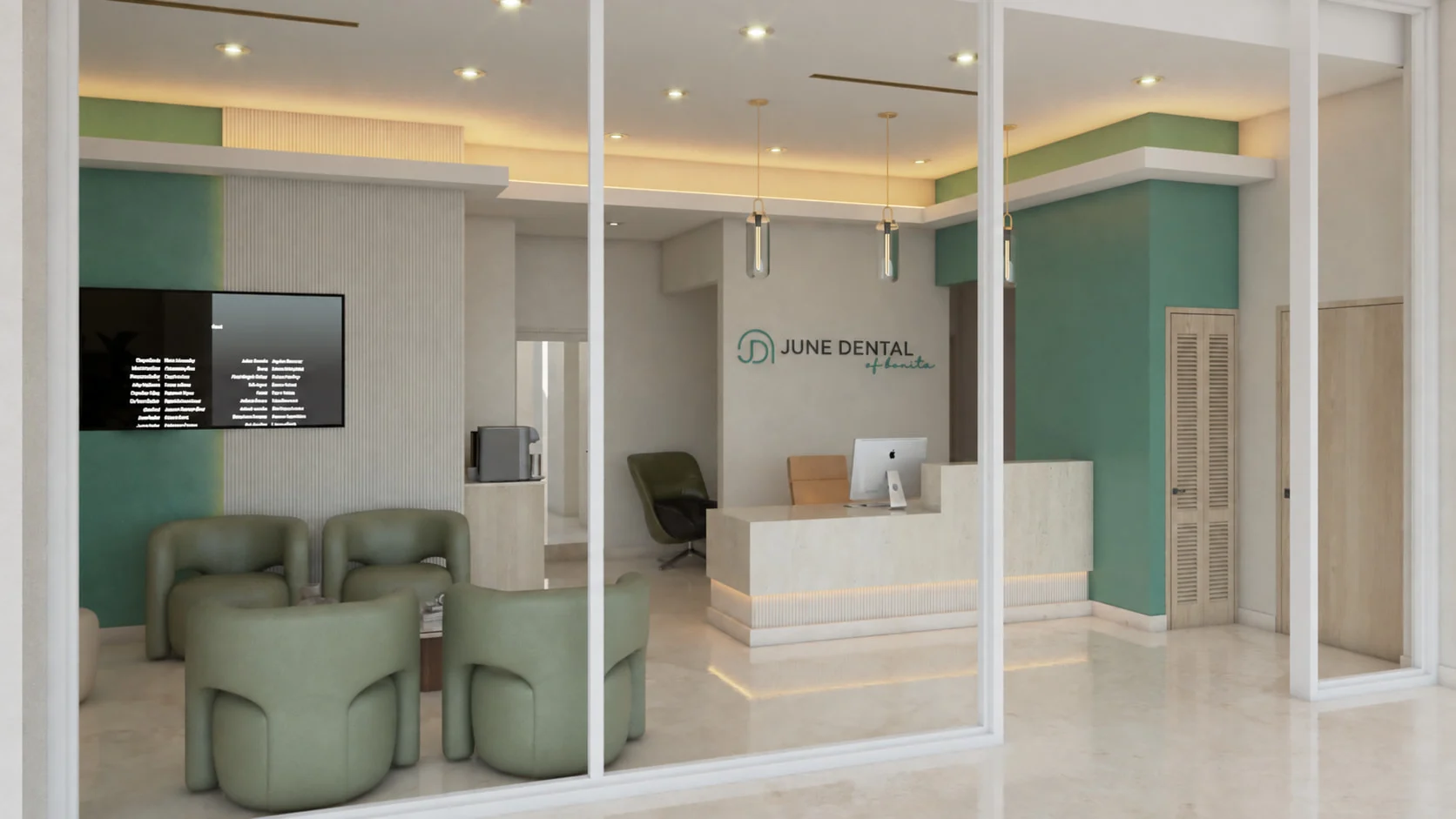 June Dental — Angled view through the glass front of green armchairs, the reception desk and glass pendant lights