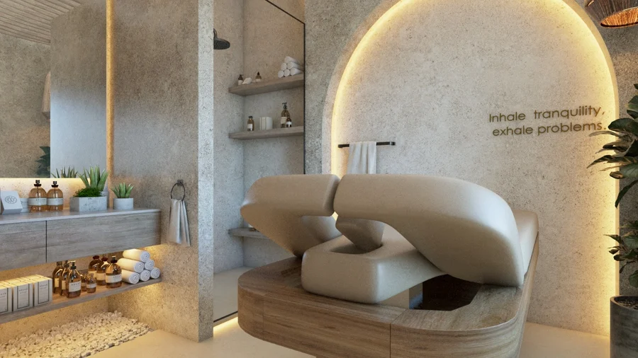Treatment room where an arch lettered “Inhale tranquility, exhale problems.” frames a sculpted beige bed