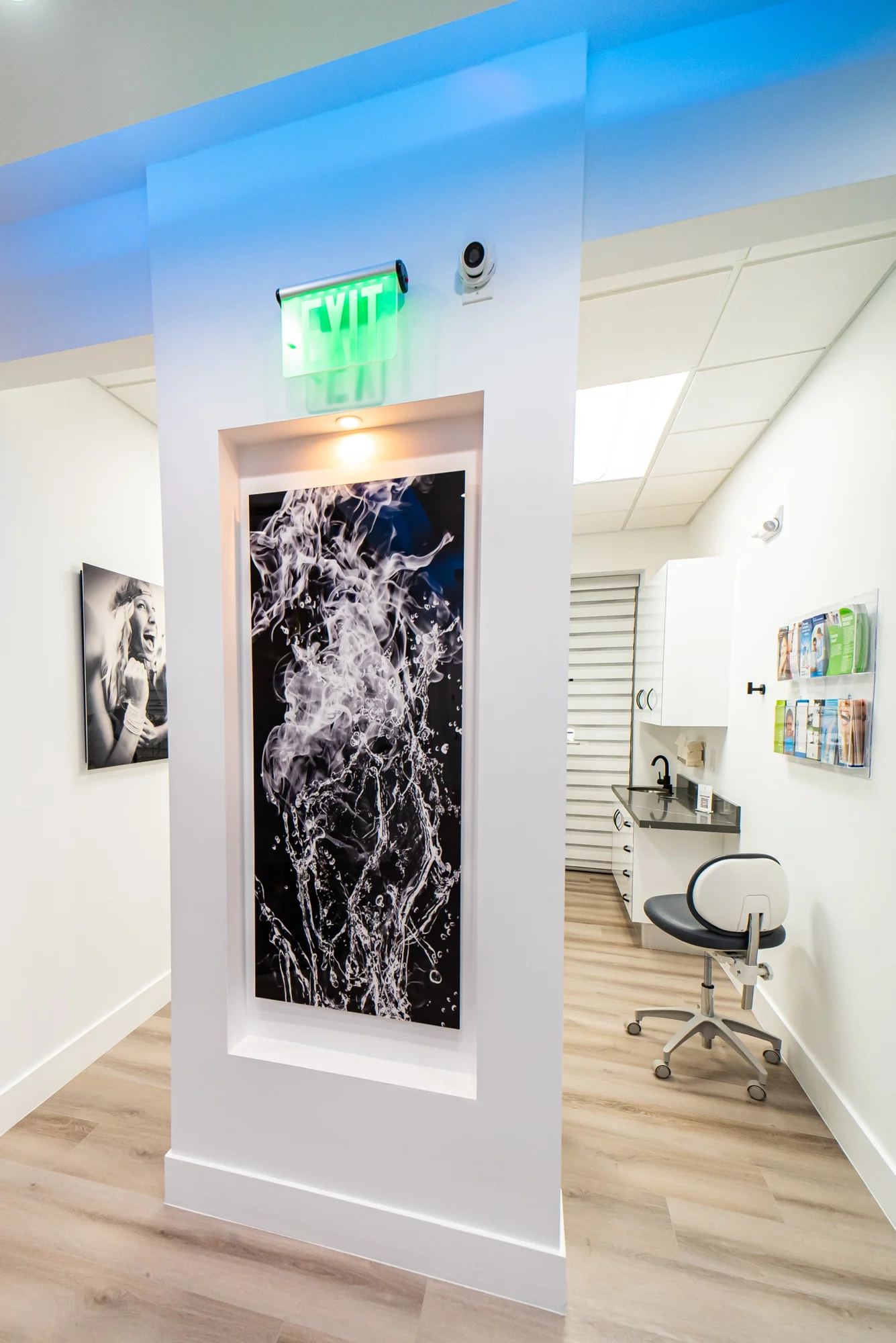 Select Dental Care — Black-and-white panel of splashing water in a lit niche, below an exit sign