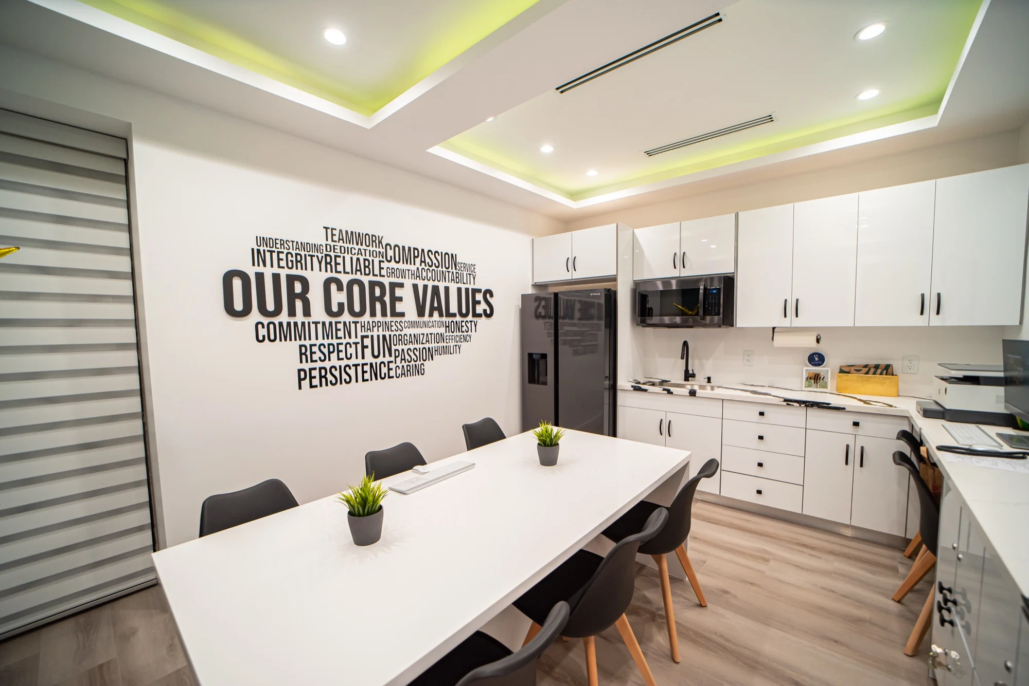 Select Dental Care — Staff room with an OUR CORE VALUES word wall, a long white table and black chairs
