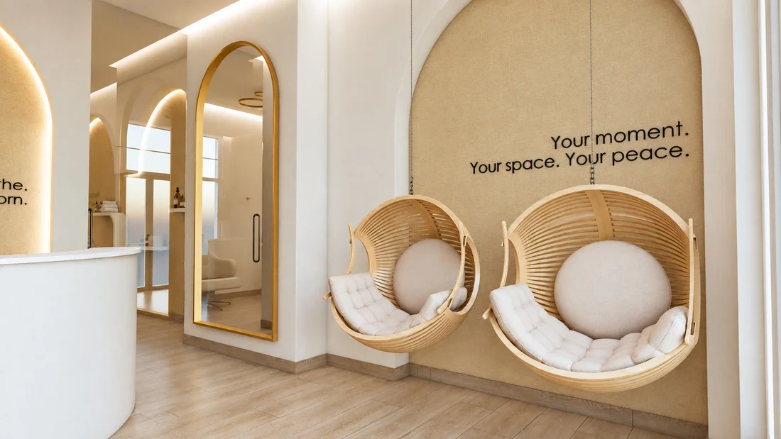 Soji Medspa — Lounge where two hanging wood-slat pod chairs sit under “Your moment. Your space. Your peace.” in an arched niche