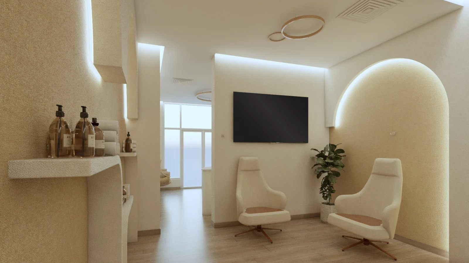 Soji Medspa — Lounge with two cream swivel chairs by a backlit arch, a ring ceiling light and shelves of amber bottles